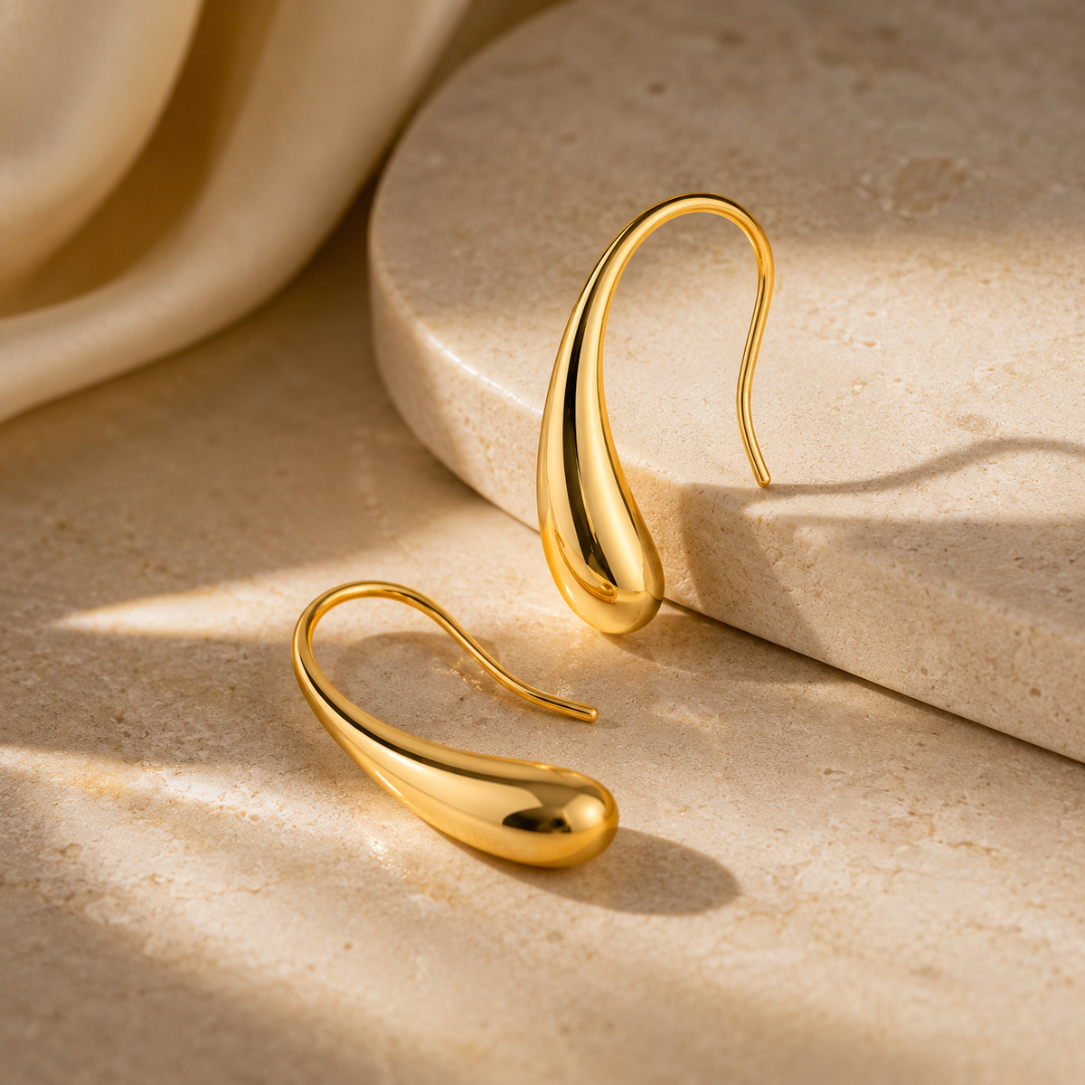 Amara Studs by JouJule, sculptural gold-tone drop earrings with fluid curved silhouette