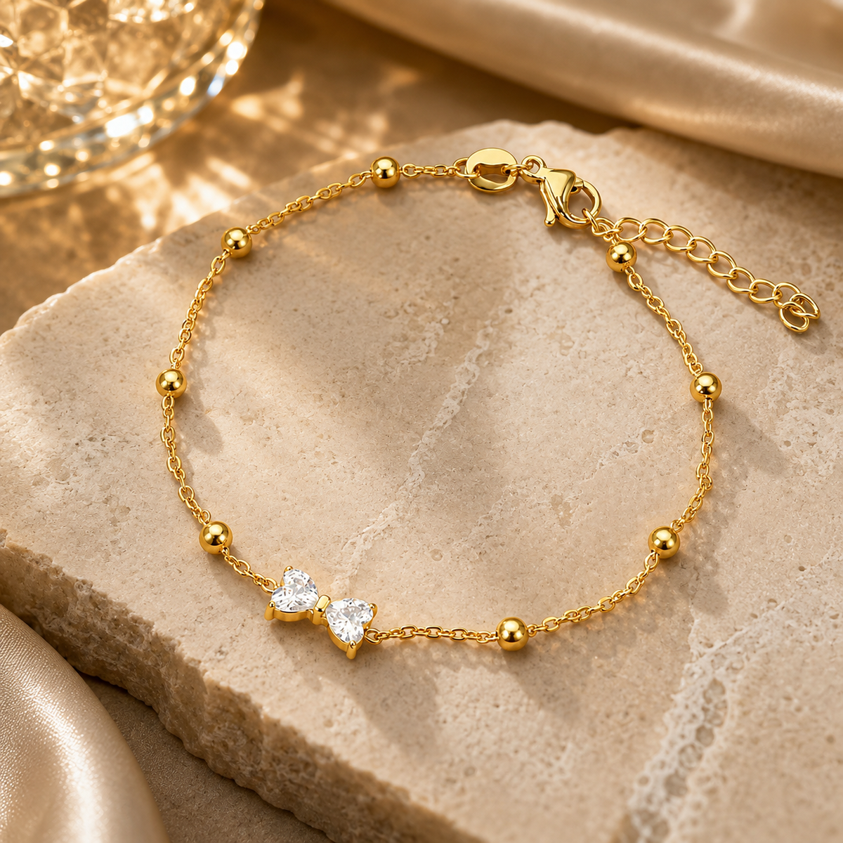 Joū Bangle by JouJule, gold-tone beaded bangle with double-heart centerpiece