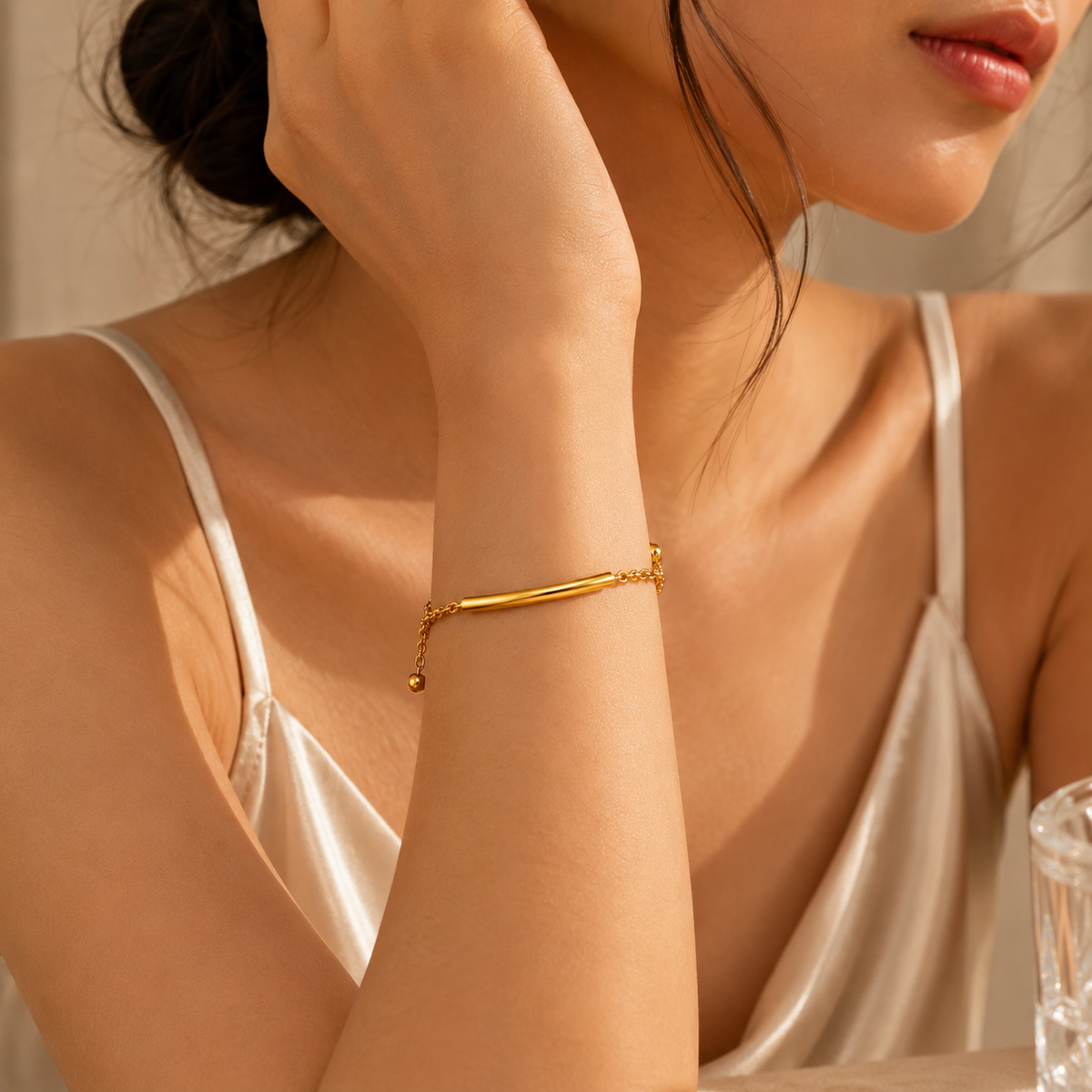 Joū Cuff by JouJule gold-tone curved bar cuff bracelet styled on model