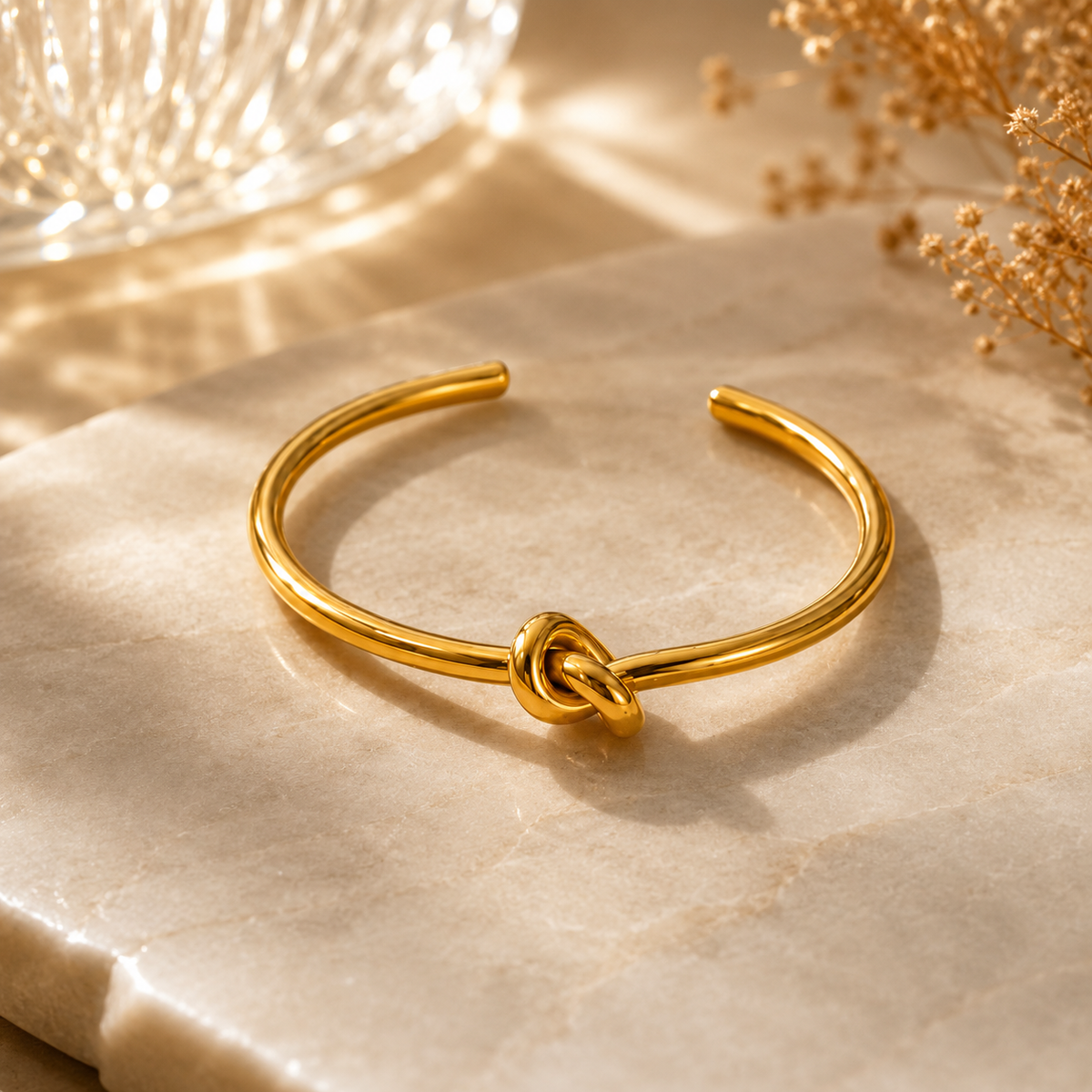 Liora Bangle by JouJule, sculptural gold-tone open bangle with distinctive knot detail