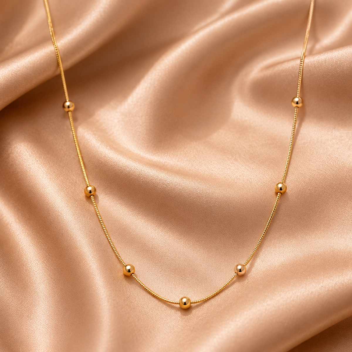Marlowe Link by JouJule, gold-tone beaded chain necklace with polished spherical accents